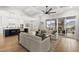 Open-concept living room with hardwood floors, a fireplace, and seamless flow to the kitchen and outdoor porch at 329 Broad Elm Ln, Apex, NC 27523