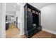 Mudroom with custom shelving, drawers, bench, and hardwood floors at 329 Broad Elm Ln, Apex, NC 27523