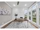 Well-lit office with wainscoting, large windows, desk and decorative rug with beautiful hardwood floors at 329 Broad Elm Ln, Apex, NC 27523