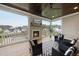 Inviting covered porch with a cozy fireplace, TV, comfortable seating, and views of the neighborhood at 329 Broad Elm Ln, Apex, NC 27523