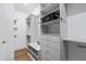 Organized walk-in closet with shelving, drawers, and ample storage space, with a safe at 329 Broad Elm Ln, Apex, NC 27523