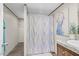 Well-lit bathroom with a single vanity, shower with curtain, and decorative peacock art at 332 Eastfield Dr, Rocky Mount, NC 27801