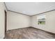 Spacious bedroom with wood-look floors and a window overlooking the neighborhood at 332 Eastfield Dr, Rocky Mount, NC 27801