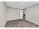 A simple bedroom boasts wood-look floors, white doors, and a view into the kitchen at 332 Eastfield Dr, Rocky Mount, NC 27801