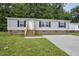 Charming single-story home with gray siding, brick foundation, and a well-manicured lawn at 332 Eastfield Dr, Rocky Mount, NC 27801