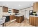Well-lit kitchen features wooden cabinets, a center island, black appliances, and neutral countertops at 332 Eastfield Dr, Rocky Mount, NC 27801