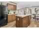 Kitchen features wooden cabinets, neutral countertops, black appliances, and a center island at 332 Eastfield Dr, Rocky Mount, NC 27801