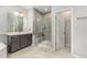 Bathroom with a glass enclosed shower and a dark wood vanity at 352 Fire Opal Ln, Holly Springs, NC 27540