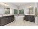 Bright bathroom featuring a corner tub, dual sinks, and modern fixtures at 352 Fire Opal Ln, Holly Springs, NC 27540