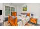 Cozy bedroom with a wooden bed frame, a landscape painting and natural light from the window at 352 Fire Opal Ln, Holly Springs, NC 27540
