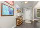 Inviting entryway featuring dark hardwood floors and stylish decor; gallery wall with paintings at 352 Fire Opal Ln, Holly Springs, NC 27540