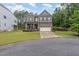 Attractive two-story home featuring a brick facade, two car garage, and a covered porch at 352 Fire Opal Ln, Holly Springs, NC 27540