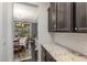 Bright kitchen featuring granite countertops, subway tile backsplash and an open view into the dining room at 352 Fire Opal Ln, Holly Springs, NC 27540