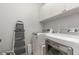 Efficient laundry room with modern washer and dryer, providing convenience and functionality at 352 Fire Opal Ln, Holly Springs, NC 27540