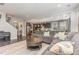 Open-concept living room with a large sectional couch, many windows, and dark hardwood floors at 352 Fire Opal Ln, Holly Springs, NC 27540