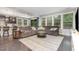 Spacious living room with a large gray sectional couch and many windows for natural light at 352 Fire Opal Ln, Holly Springs, NC 27540