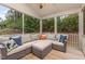 Comfortable screened-in porch with cozy seating, perfect for relaxing and enjoying the outdoors at 352 Fire Opal Ln, Holly Springs, NC 27540