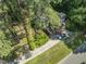 An aerial view of the home, showcasing its manicured landscaping, and driveway at 3911 Hope Valley Rd, Durham, NC 27707