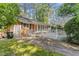 Charming brick home featuring a white wooden deck and pergola, perfect for outdoor entertaining at 3911 Hope Valley Rd, Durham, NC 27707