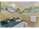 Charming bathroom with unique mural, vanity with a green countertop and decorative mirror at 3911 Hope Valley Rd, Durham, NC 27707