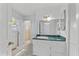 Bright bathroom with green countertop vanity and access to the shower at 3911 Hope Valley Rd, Durham, NC 27707