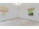 Carpeted bedroom features abundant natural light and neutral decor at 3911 Hope Valley Rd, Durham, NC 27707