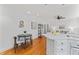 A bright open-concept dining area with hard wood floors adjacent to kitchen and living spaces at 3911 Hope Valley Rd, Durham, NC 27707