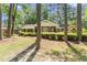 Classic brick home featuring well-maintained landscaping and mature trees, exuding timeless charm at 3911 Hope Valley Rd, Durham, NC 27707