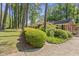 Well-maintained brick home with beautiful landscaping, enhanced by mature trees and a manicured lawn at 3911 Hope Valley Rd, Durham, NC 27707