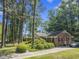 Charming brick home with manicured landscaping, mature trees, and a welcoming front porch at 3911 Hope Valley Rd, Durham, NC 27707