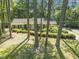 Traditional brick home with manicured landscaping, set amidst towering trees, offering shade and privacy at 3911 Hope Valley Rd, Durham, NC 27707