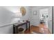 Bright foyer with hardwood floors, white trim, and a view into the living area at 3911 Hope Valley Rd, Durham, NC 27707