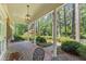Inviting front porch with brick flooring, columns, and beautiful landscaping, offering a serene outdoor space at 3911 Hope Valley Rd, Durham, NC 27707