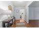 Bright hallway with hardwood floors, white trim, and a view into the living area at 3911 Hope Valley Rd, Durham, NC 27707
