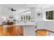 Open-concept kitchen with breakfast bar flowing into a bright living room with beautiful hard wood floors at 3911 Hope Valley Rd, Durham, NC 27707