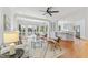 Open-concept living area featuring hardwood floors, white trim, and seamless flow to kitchen at 3911 Hope Valley Rd, Durham, NC 27707