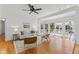Bright living room with hardwood floors and white walls open to the backyard through beautiful glass doors at 3911 Hope Valley Rd, Durham, NC 27707