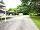 Large backyard with a covered parking area and a storage shed, perfect for outdoor activities at 404 Oakgrove Dr, Graham, NC 27253