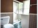 Bathroom with a shower, a white toilet, and a white sink at 404 Oakgrove Dr, Graham, NC 27253