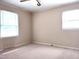 Bedroom featuring two bright windows, neutral paint, and carpeting at 404 Oakgrove Dr, Graham, NC 27253