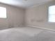 Neutral bedroom with carpet, two windows, and ample natural light at 404 Oakgrove Dr, Graham, NC 27253
