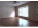Bright living room featuring a large window, ceiling fan, and hardwood floors at 404 Oakgrove Dr, Graham, NC 27253