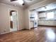Spacious living room open to the kitchen, with hardwood floors and ceiling fans at 404 Oakgrove Dr, Graham, NC 27253