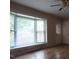 Bright living room features a large bay window and hardwood floors, creating a welcoming atmosphere at 404 Oakgrove Dr, Graham, NC 27253