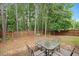 Private backyard with mature trees and patio area, perfect for outdoor entertaining at 404 Straywhite Ave, Apex, NC 27539