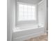 Bright bathroom with a soaking tub and tiled flooring at 404 Straywhite Ave, Apex, NC 27539