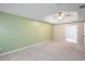 Generously sized bedroom with a tray ceiling, ceiling fan, and a neutral carpet at 404 Straywhite Ave, Apex, NC 27539