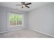 Light-filled bedroom with plush carpet, neutral walls, and a ceiling fan for added comfort at 404 Straywhite Ave, Apex, NC 27539