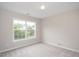Inviting bedroom with plush carpeting, a large window, and neutral decor for a serene atmosphere at 404 Straywhite Ave, Apex, NC 27539