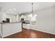 Open-concept dining area adjacent to the kitchen, featuring hardwood floors and bright lighting at 404 Straywhite Ave, Apex, NC 27539
